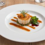 Gourmet plated dish with elegant presentation and garnish