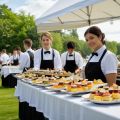Catering staff serving elegant dishes at outdoor event
