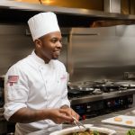 Chef Marcus Johnson presenting gourmet dish